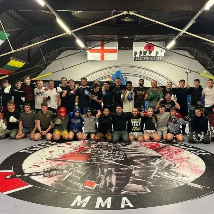 Custom printed MMA gym floor canvas — Fighter Blueprint Academy branded mat with sponsor logos